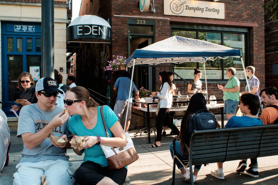 The Iowa City Downtown District's Taste of Iowa City drew locals and visitors from a little further afield on Wednesday, August 22nd, 2018. Eventgoers  consumed small dishes from all the participating restaurants, getting a 'taste' of the local food scene. Kyle Barnes lets his wife, Sarah Barnes, try some of his bao bun from Dumpling Darling. Sarah said she's wanted to come for a few years, but has always been working the 2nd shift, but this year she made sure to switch to the first shift today. 