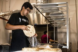 Kavir Ramos puts tortillas into a bag at Tortilla Chihuas on Wednesday, Oct. 17, 2018. Ramos is a DACA recipient and opened the factory to model his grandmother's recipes.