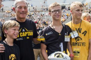 Kid Captain Gabe Graber takes a photo with his family and Iowa head coach Kirk Ferentz during Iowa Football Kid's Day at Kinnick Stadium on Saturday, August 11, 2018. The 2018 Kid Captains met the Iowa football team and participated in a behind-the-scenes tour of Kinnick Stadium. Gwen's story will be featured during Iowa's first home game on Saturday. (Katina Zentz/The Daily Iowan)