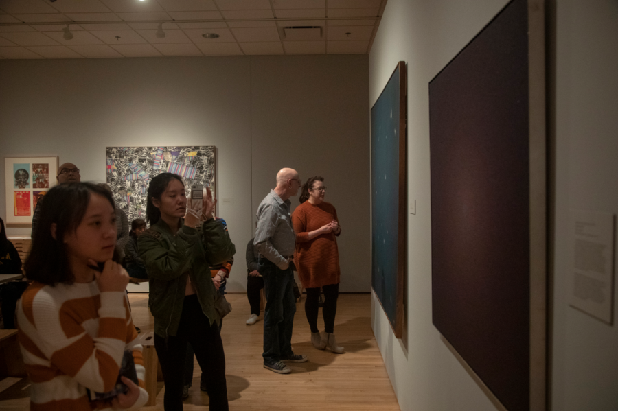 Attendees observe artwork during a Pointillism workshop at the Stanley Art Museum on Saturday March 9. The event was a collaboration between the art and theater department. 