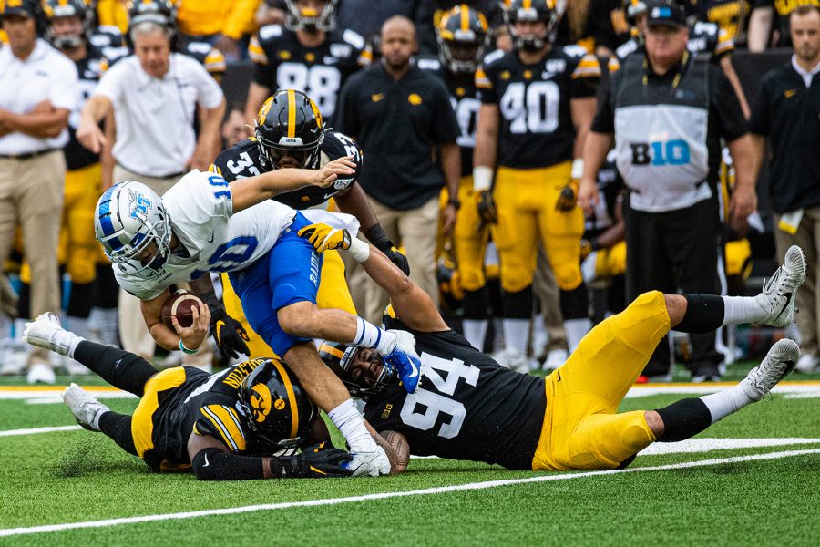 Iowa defenders converge on MTSU quarterback Asher O'Hara during a football game between Iowa and Middle Tennessee State at Kinnick Stadium on Saturday, September 28, 2019. The Hawkeyes defeated the Blue Raiders, 48-3. 