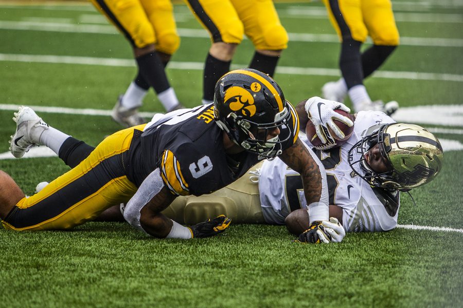 Iowa defensive back Geno Stone attempts to defend Purdue running back King Doerue during the Iowa football game against Purdue at Kinnick Stadium on Saturday, Oct. 19, 2019. The Hawkeyes defeated the Boilermakers 26-20.