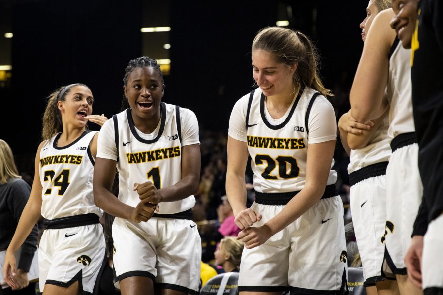 Iowa players Gabbie Marshall, Tomi Taiwo, and Kate Martin celebrate as the Hawkeyes win during a womenÕs basketball game between Iowa and Princeton at Carver-Hawkeye Arena on Wednesday, November 20, 2019.