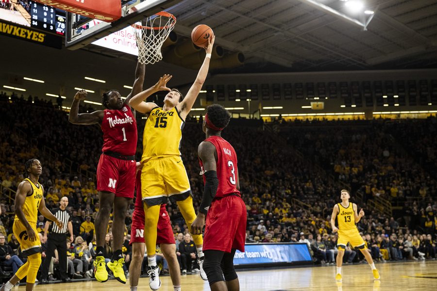 Iowa forward Ryan Kriener goes in for the shot while Nebraska Guard Kevin Cross attempts to block during a men’s basketball game between the Iowa Hawkeyes and the Nebraska Huskers at Carver-Hawkeye arena on Saturday, February 8, 2020. The Hawkeyes defeated the Huskers 96-72. 