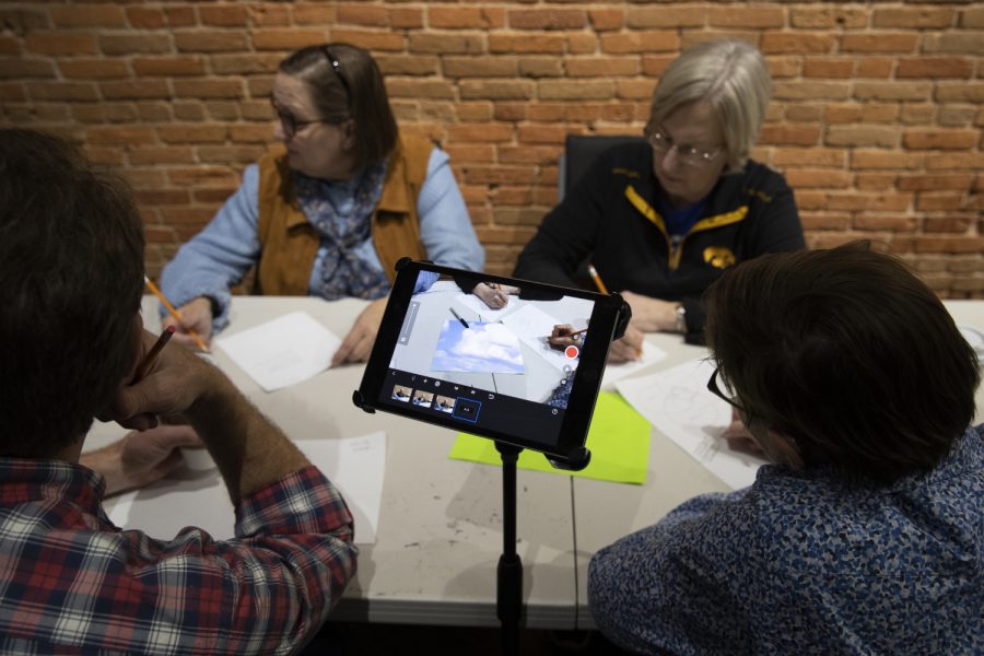 Atkins family members work works on their green screen film during the Adult Animation Camp at Film Scene in the Ped Mall on Sunday, Feb. 23, 2020. The family traveled to Iowa City for a reunion at the animation camp.