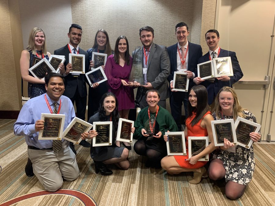 Daily Iowan staff members hold first-place plaques and the 2020 Newspaper of the Year award to celebrate earning the Iowa Newspaper Association’s top honor at the association’s annual awards convention at the Des Moines Marriott Downtown on Feb. 7. The achievement marks the first time the DI has won Newspaper of the Year since 1981.