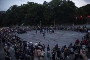A crowd participating in a march to support the Black Lives Matter movement and protest police brutality stops at the intersection of Burlington Street and Riverside Drive to spray paint the intersection and chant in support of their cause.