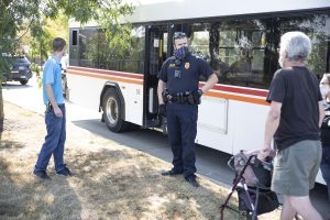 Officer A. Farrell ICPD pratices safety by maintaining 6 feet distance, wearing a mask and gloves, while talking to bus passengers at  Walmart 919 Hwy. 1, W. . seen on Saturday, Sep.5,2020.