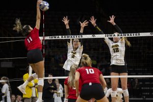 Courtney Buzzerio and Hannah Clayton try to stop the Huskers from scoring during the Iowa and Nebraska volleyball game. The Huskers defeated the Hawkeyes in three sets on November 9, 2019, at Carver-Hawkeye Arena. 