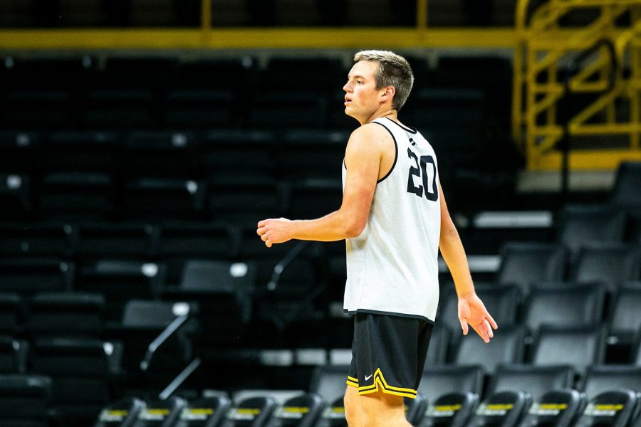 Iowa center Payton Sandfort (20) runs a drill during NCAA men's basketball practice, Monday, Oct. 11, 2021, at Carver-Hawkeye Arena in Iowa City, Iowa.