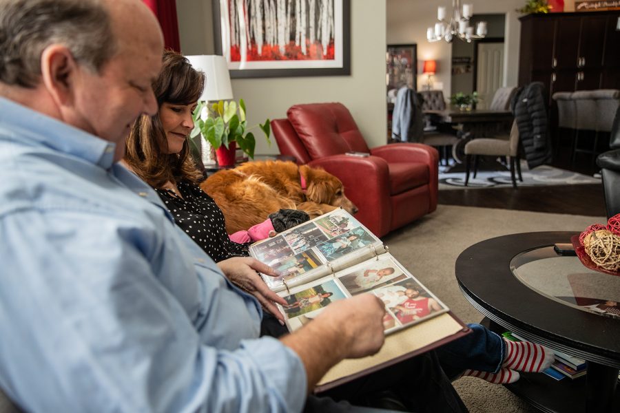 Dale and Juli Wirtjes look at old photo albums at their house in Cedar Rapids on Saturday, Feb. 12, 2022. Juli and Dale have been married for almost 40 years. 