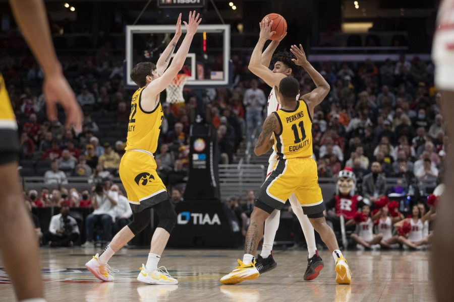 Rutgers guard Geo Baker gets trapped by Iowa guard Tony Perkins and forward Patrick McCaffery during a men’s basketball game between No. 5 Iowa and No. 4 Rutgers in the Big Ten Basketball Tournament quarterfinals at Gainbridge Fieldhouse in Indianapolis on Friday, March 11, 2022. The Hawkeyes defeated the Scarlet Knights, 84-74. Iowa forced 5 turnovers. 