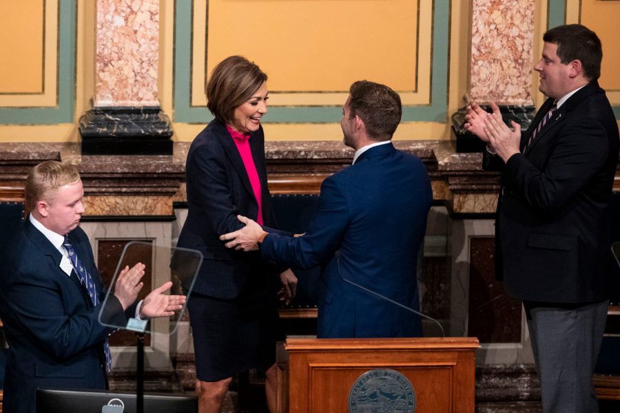 Iowa Governor Kim Reynolds shakes hands with Senate President Jake Chapman during the Condition of the State Address at the Iowa State Capitol in Des Moines, Iowa, on Tuesday, Jan. 11, 2022. During the State Address, Reynolds spoke about childcare, Iowa teachers, material taught in schools, unemployment, tax cuts, and more.