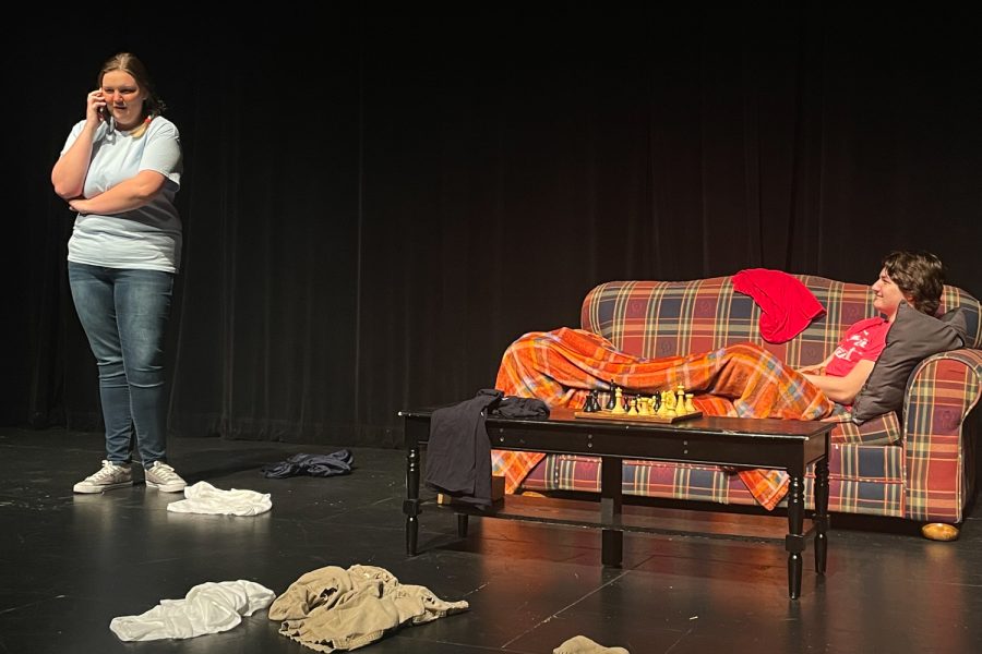 Trinity Christofferson, playing the role of the Mom, takes a call while Charlie Schmelzer, playing the role of Bobby, listens at the University of Iowa Theatre Building on Wednesday, Oct. 16, 2022. Contributed photo of Jordan "JJ" Jones of a dress rehearsal.