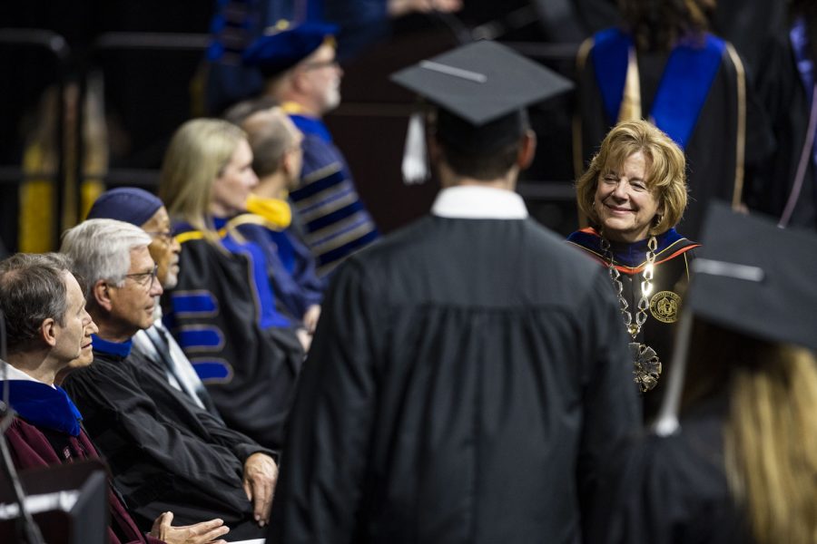 University of Iowa President Barbara Wilson shakes a graduate’s hand during the University of Iowa's spring 2023 Commencement Ceremony for the College of Liberal Arts and Sciences at Carver-Hawkeye Arena on Saturday, May 13, 2023. The ceremony marks one of two Liberal Arts and Sciences ceremonies.