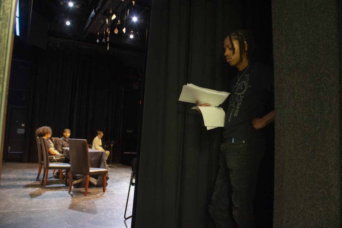 Kylen Phillips reads his lines backstage during a performance of West Illinois Glass House in the Iowa Theatre Building on Thursday, Feb. 15, 2024. (Ava Neumaier/The Daily Iowan)
