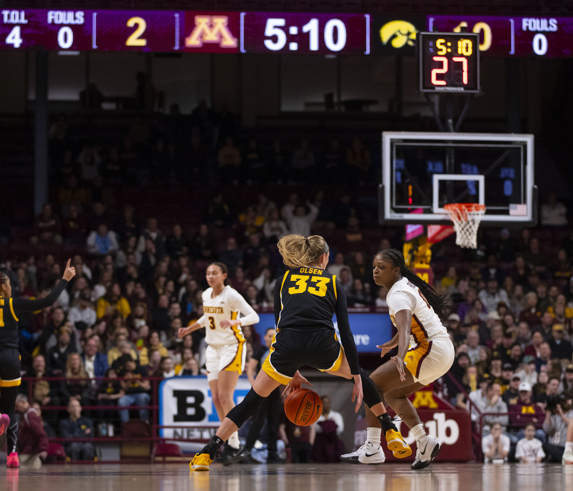 Lucy Olsen dribbles the ball during a women's basketball game between Iowa and Minnesota at Williams Arena in Minneapolis, Minnesota, on Thursday, Feb. 6, 2025. The Iowa Hawkeyes defeated the Minnesota Golden Gophers 68-60.