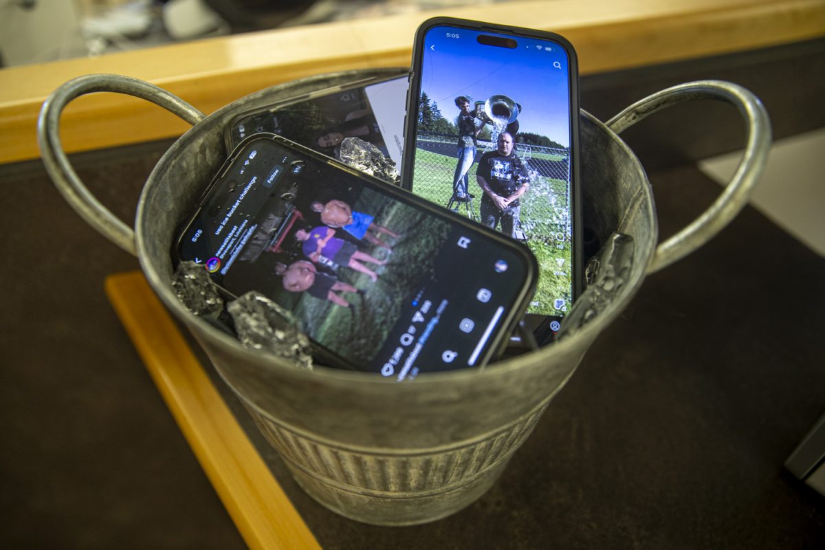 A bucket full of phones showing the USC Speak Your Mind Challenge is seen on Tuesday, May 6, 2025. This new spin on the Ice Bucket Challenge has received enormous participation and equal criticism.